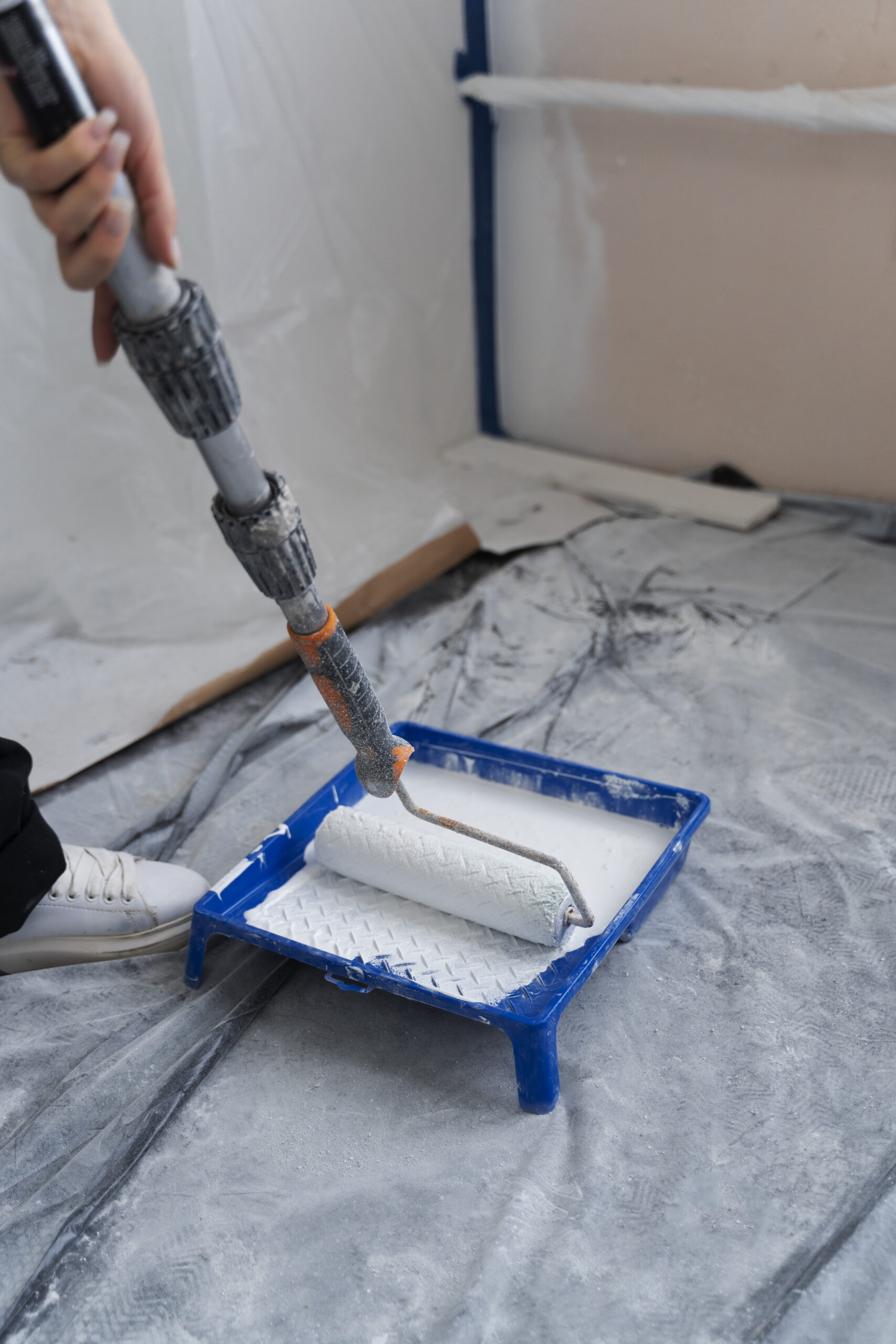 construction worker using paint roller